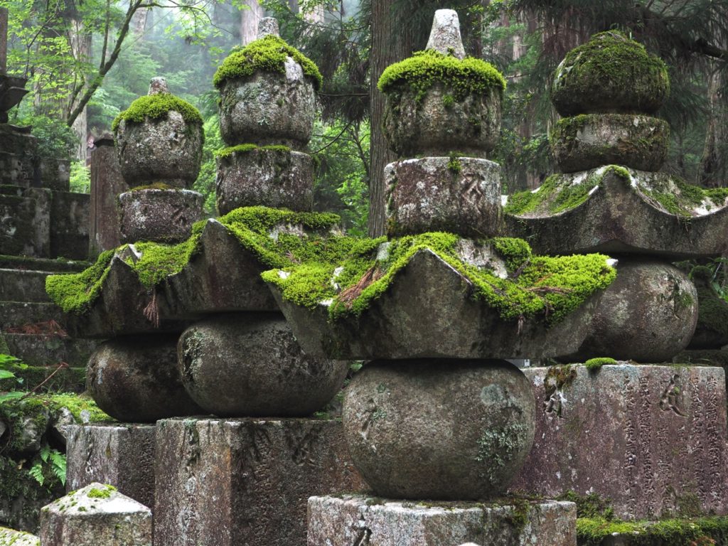 Gravestones are covered in moss in Okunoin Cemetery – Japan's largest cemetery – at Mount Koyasan. The cemetery is set high amongst 600-year-old cedar trees, where mountain fog creates a mysterious atmosphere. Image: Alison Binney